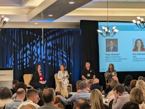 This is a picture from the 2024 Advance CTE Fall Meeting Plenary panel about the Modernized Career Clusters Framework. It features, from left to right, Dr. Katie Graham (NE State CTE Director), Eva Mitchell (CEO, Coalition for Career Development), Trey Michael (NC State CTE Director), and Melissa Rekeweg (Managing Director, National Council for Agricultural Education; Associate Director, National FFA).